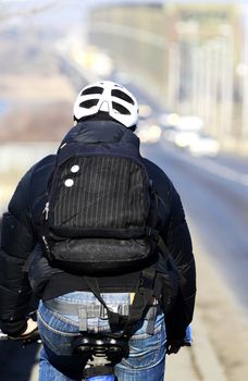 View from the back on cyclists with helmet and backpack