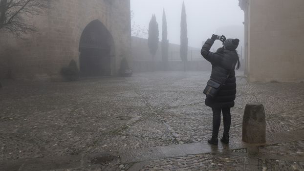 Woman shooting photograph in the fog