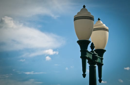 Low angle view of classic lighting pole against blue sky