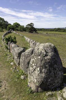 Stone ship on Gotland, Sweden with a partly cloudy sky.
