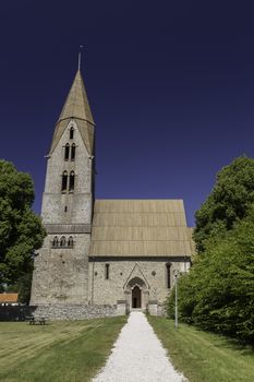 Church at Oja, Gotland, Sweden with a clear blue sky.