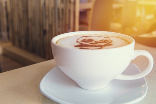 latte art coffee or cappuccino on wooden table background.