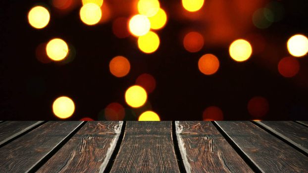 Perspective wood and bokeh background of night and the shimmering glare of the lights. display template item.