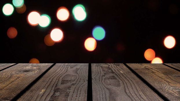 Perspective wood and bokeh background of night and the shimmering glare of the lights. display template item.