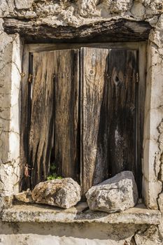 Old wodden window shutter of traditional house in the village Chamaitoulo, Crete, Greece.