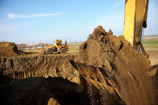Big excavator in action on construction site