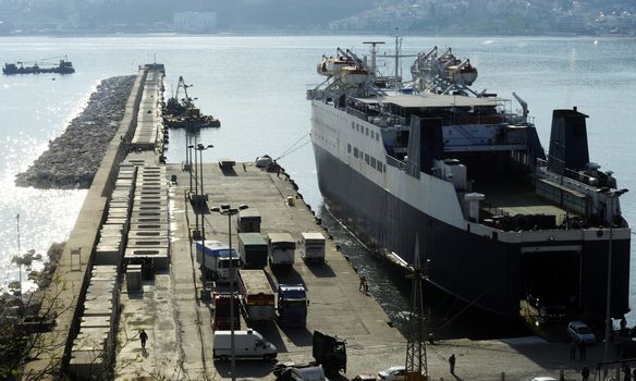 Ferry boat in port embarking passengers on a sunny day