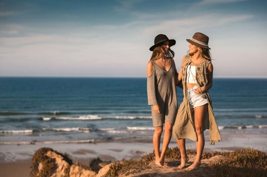 Two best friends near the coastline having fun on a beautiful summer day