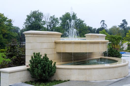 Beautiful fountain splashing water on a sunny day