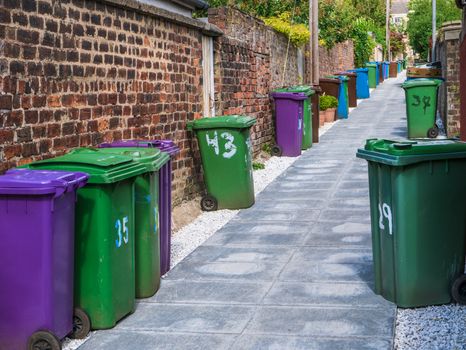 A Row Of Wheelie Bins In An Alleyway In A British City