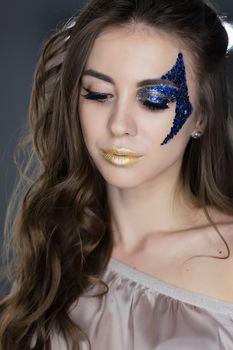 Fashion makeup. Woman with colorful makeup and body art.