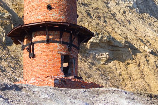 Destroyed a two-story brick building on the background of the mountains.