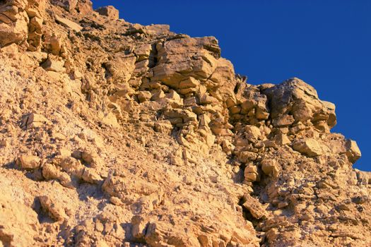 Close-up of stone rock with blue sky above