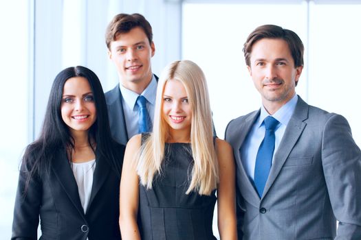 Happy business team of coworkers in office