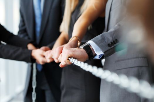 Businessmen pulling chain, teamwork togetherness concept