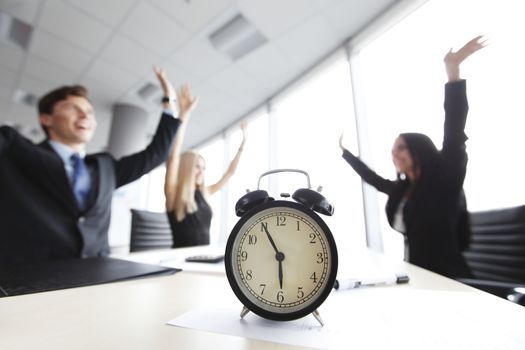 Businessmen in office and alarm clock, deadline concept