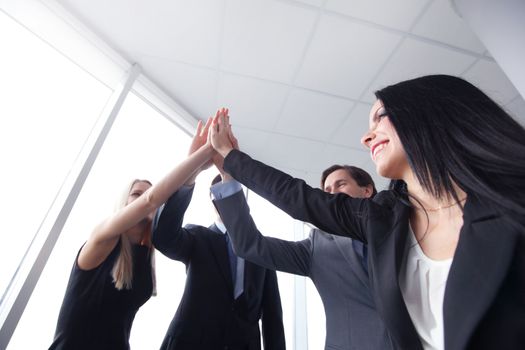 Happy business people hands giving high five 