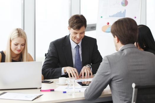 Business people analyzing financial reports in office