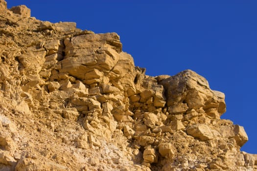Close-up of stone rock with blue sky above