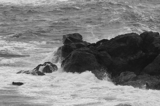 storm on the ocean. huge waves and rocks. dander for ships concept