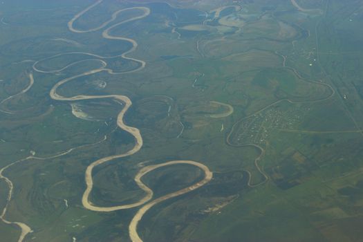 top view on a river fron a plain