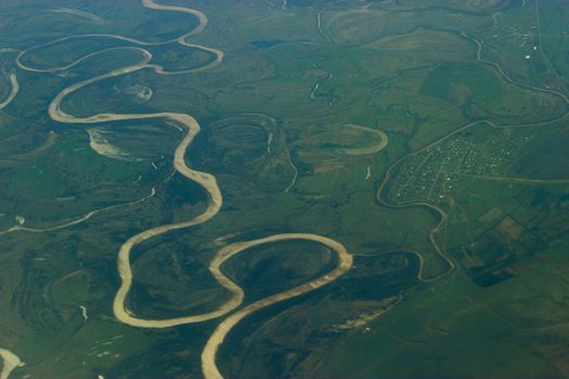 top view on a river fron a plain