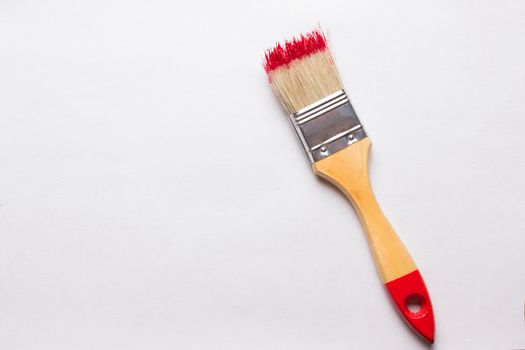 construction brush with red paint. copy space