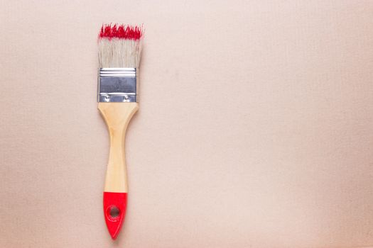 construction brush with red paint. copy space