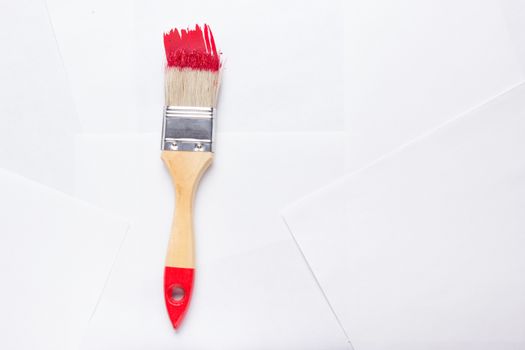 construction brush with red paint. copy space