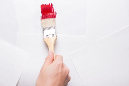construction brush in hand on white background. not isolated. copy space