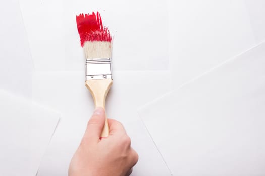 construction brush in hand on white background. not isolated. copy space