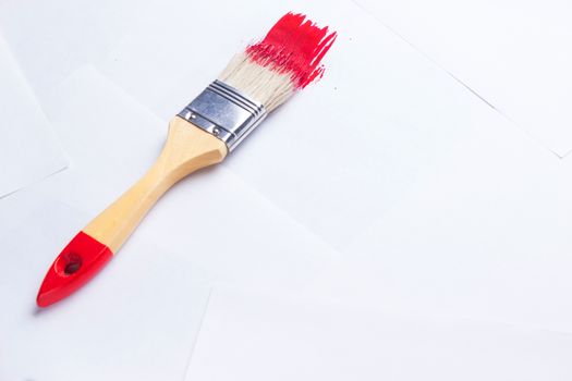 construction brush with red paint. copy space