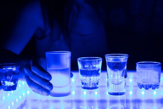 woman in a bar or club with glass of alcohol drink