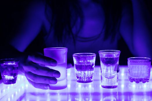 woman in a bar or club with glass of alcohol drink