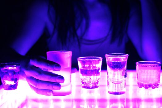 woman in a bar or club with glass of alcohol drink
