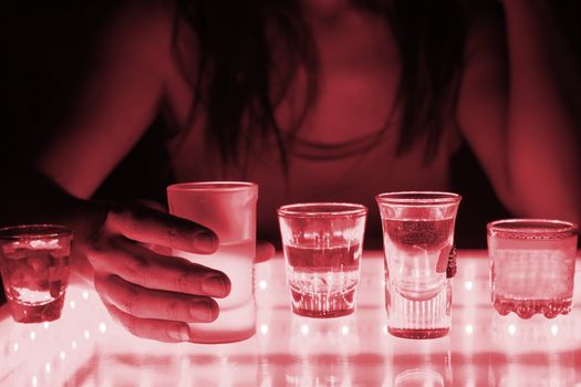 woman in a bar or club with glass of alcohol drink