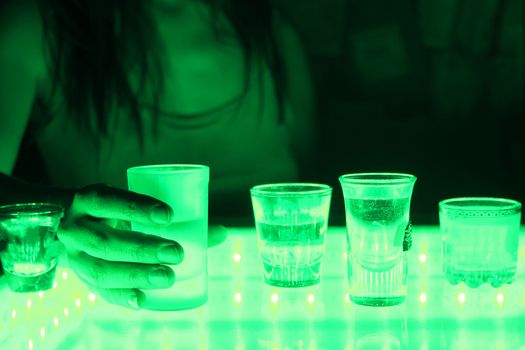 woman in a bar or club with glass of alcohol drink