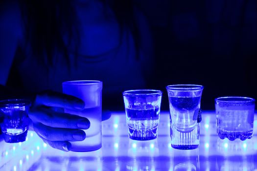 woman in a bar or club with glass of alcohol drink