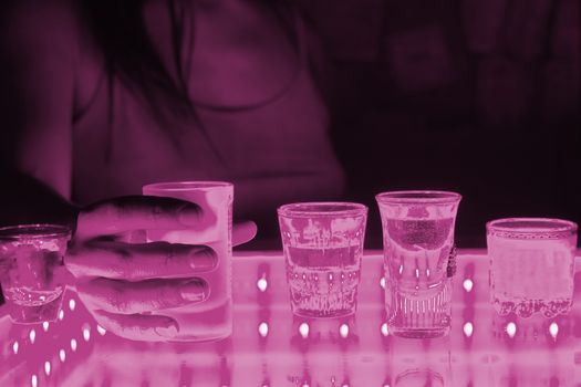 woman in a bar or club with glass of alcohol drink