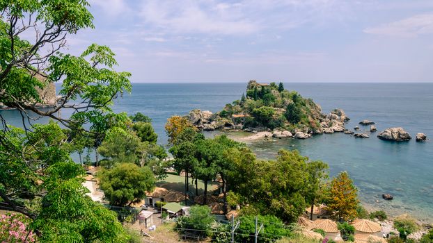 View of island and Isola Bella and blue ocean water in Taormina, Sicily, Italy