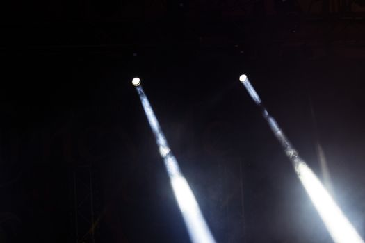 Colorful lights and smoke on a stage.