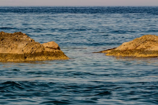 The rocks and the blue Mediterranean sea