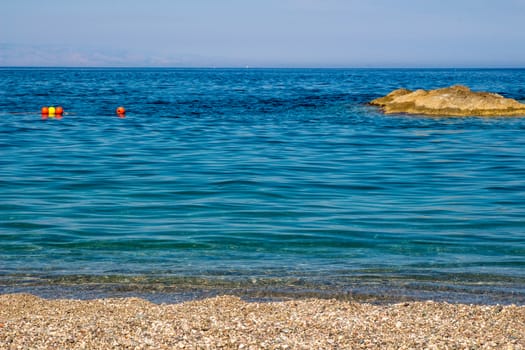 Sand the rocks and a blue Mediterranean sea