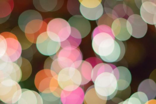 Abstract texture of colorful Christmas lights background blurs in horizontal frame