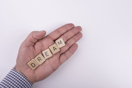 the word "dream" written with letters written on wooden blocks