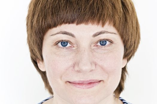 Beautiful face of woman with red hair and blue eyes on white