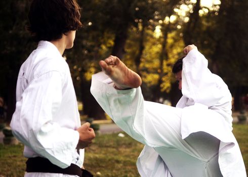 Karate training in park during summer day
