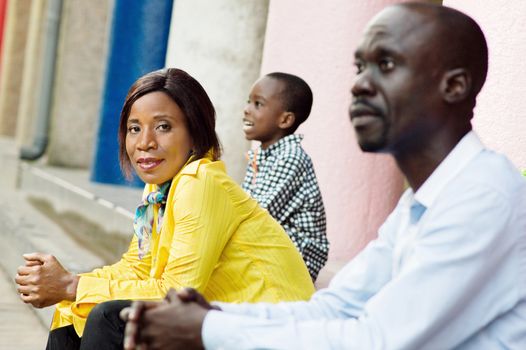 This young woman sitting and framed by her child and her husband watched the camera.