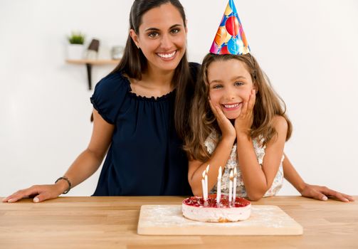 Shot of a mother and daughter in the kitchen celebrating Daughter's birthday