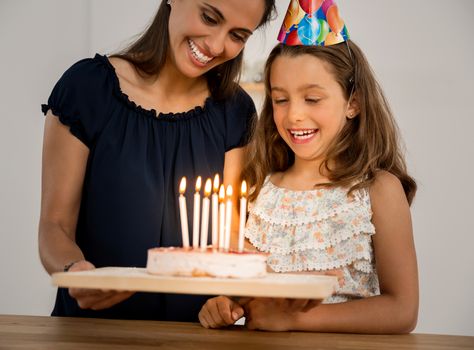 Shot of a mother and daughter in the kitchen celebrating Daughter's birthday
